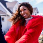 Brandy Norwood as Jackie in Best. Christmas. Ever!, standing in front of the house. Photo credit: Scott Everett White/Netflix © 2023.