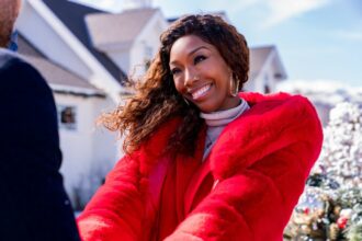 Brandy Norwood as Jackie in Best. Christmas. Ever!, standing in front of the house. Photo credit: Scott Everett White/Netflix © 2023.