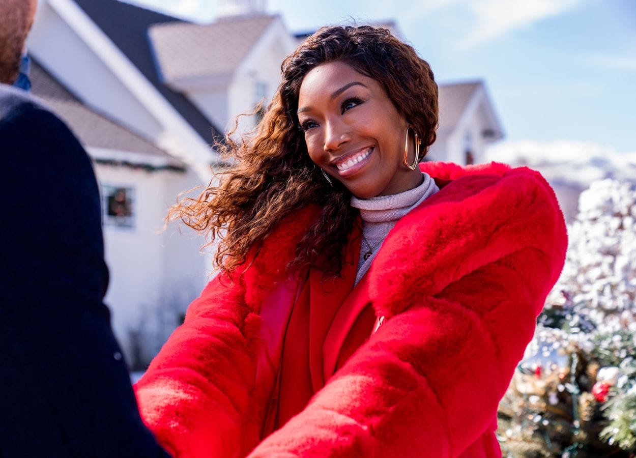 Brandy Norwood as Jackie in Best. Christmas. Ever!, standing in front of the house. Photo credit: Scott Everett White/Netflix © 2023.