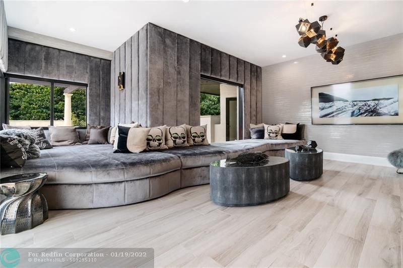 Seating area with velvet couch and walls inside Lionel Messi's house in Fort Lauderdale, Florida