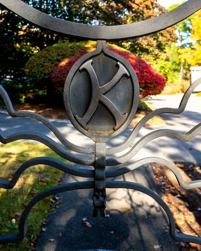 Closeup view of King`s initial on the wrought iron gate. 