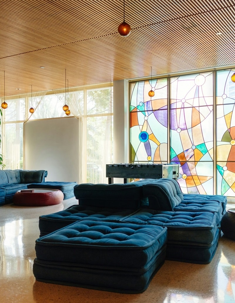 modern living area with dark blue couch and stained glass windows