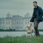 Theo James as Eddie Horniman, walking his dog on the grounds of Halstead Manor, the house in The Gentlemen TV series