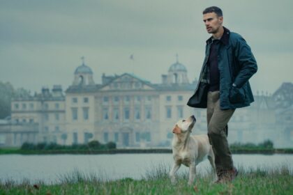 Theo James as Eddie Horniman, walking his dog on the grounds of Halstead Manor, the house in The Gentlemen TV series