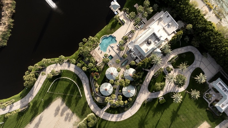 Aerial view of Merv Griffin's estate in La Quinta, Calif, showing all seven structures on the property and the man-made lake in the backyard. 