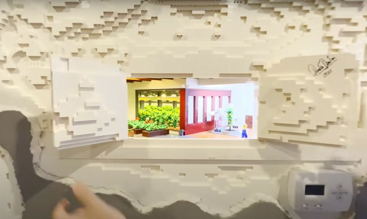 Miniature-themed rooms inside an intricate LEGO wall