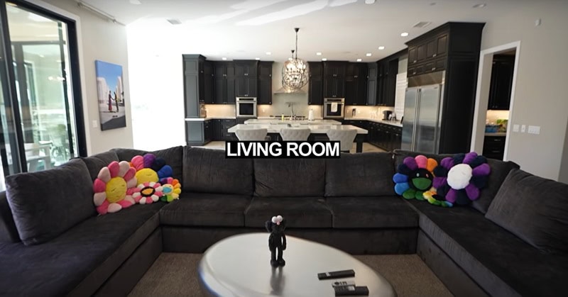 The living room sofa, with the kitchen and dining area in the background 