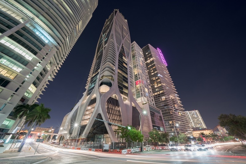 the One Thousand Museum building in Miami, seen from street level at night time.