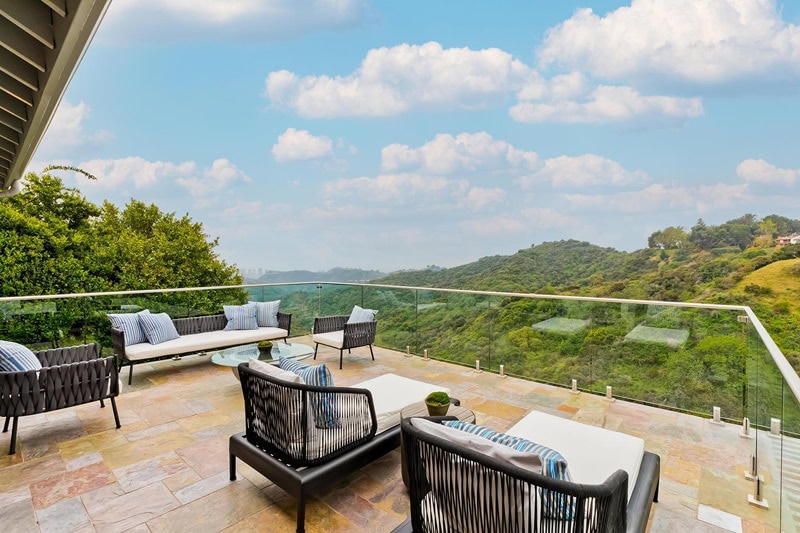 sun terrace with lots of seating options overlooking verdant mountain views.