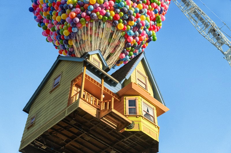 a real-life replica of the UP house showing a floating house seemingly carried away by 8,000 balloons, with a crane in view holding the house up in the air. 