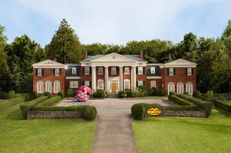 a replica of the X-Men mansion in New York, a two-story colonial brick mansion with a courtyard and a pink fallen robot head. 