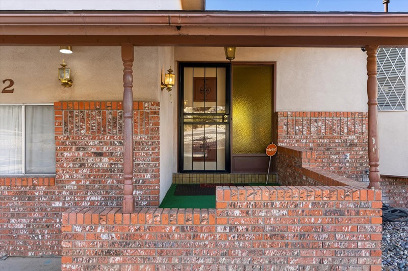 red brick entrance to a modest-looking house.