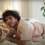 Songwriter Benny Blanco sitting on his bed