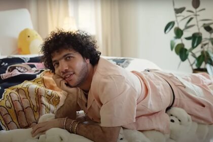 Songwriter Benny Blanco sitting on his bed