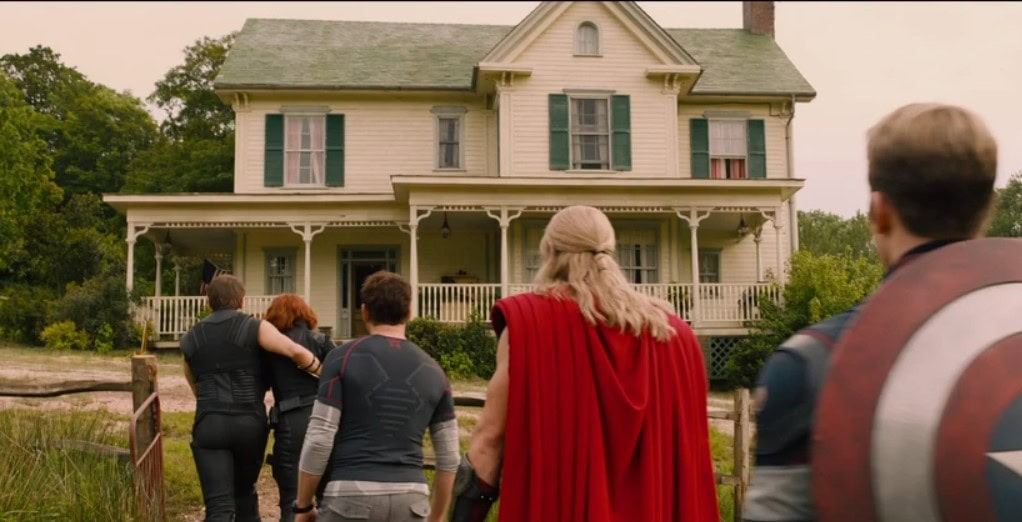 the Avengers arriving at Clint Barton's farm, with a two-story, older farmhouse in view