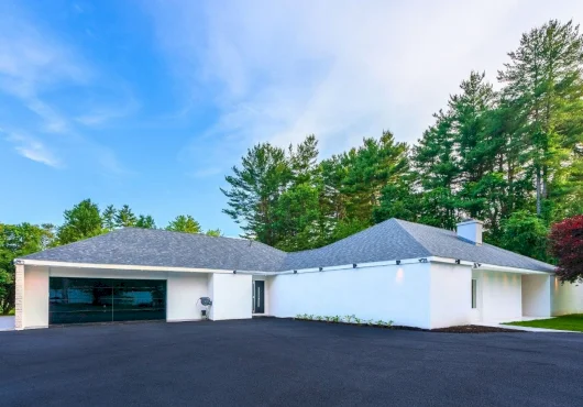 Unassuming from the outside, this $3.5M Easton house has luxe interiors, a pool at its center